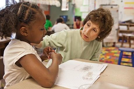 student reading to an adult